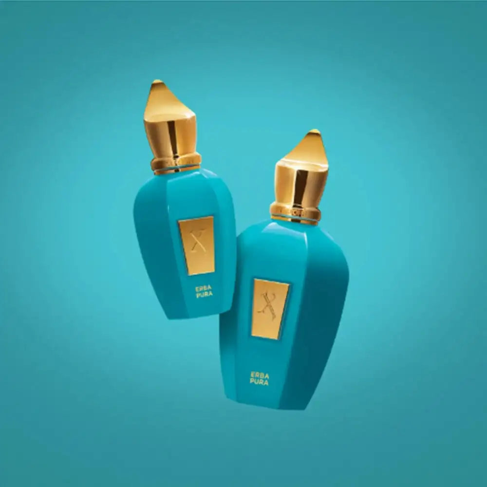 Two turquoise perfume bottles with gold stoppers floating against a plain blue background.