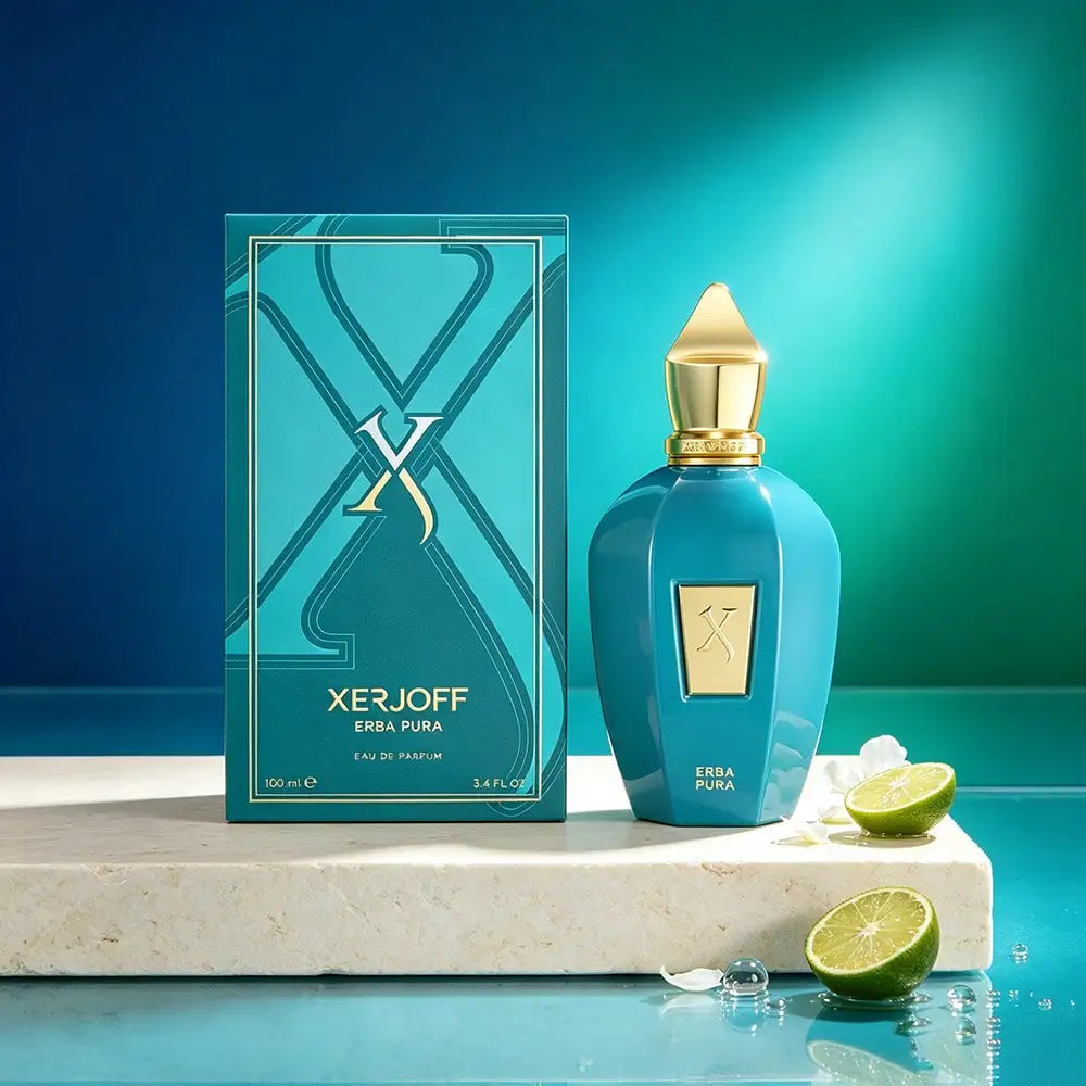 A perfume bottle and its box on a stone pedestal with lime slices and water droplets.