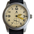 Cream colored dial field watch with black numbers and yellow hands on a black nylon strap