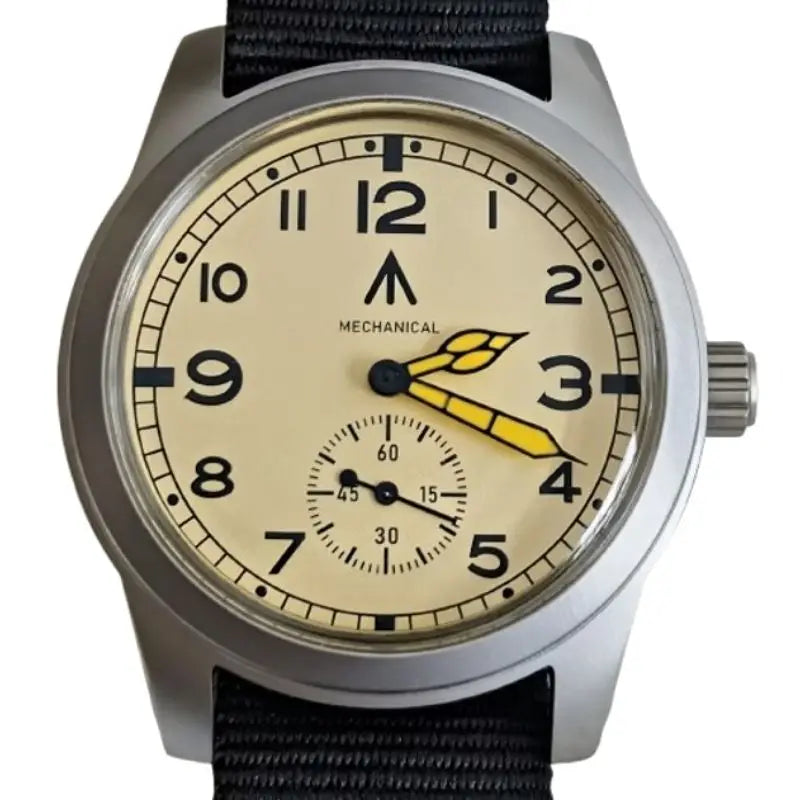 Cream colored dial field watch with black numbers and yellow hands on a black nylon strap