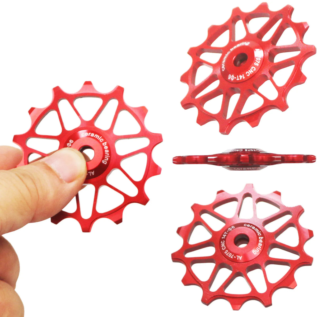 A hand holding a red ceramic bearing jockey wheel for a bicycle derailleur