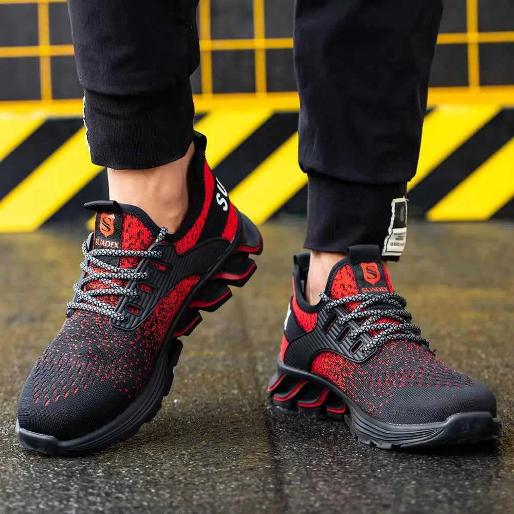 Person wearing red and black steel toe safety sneakers