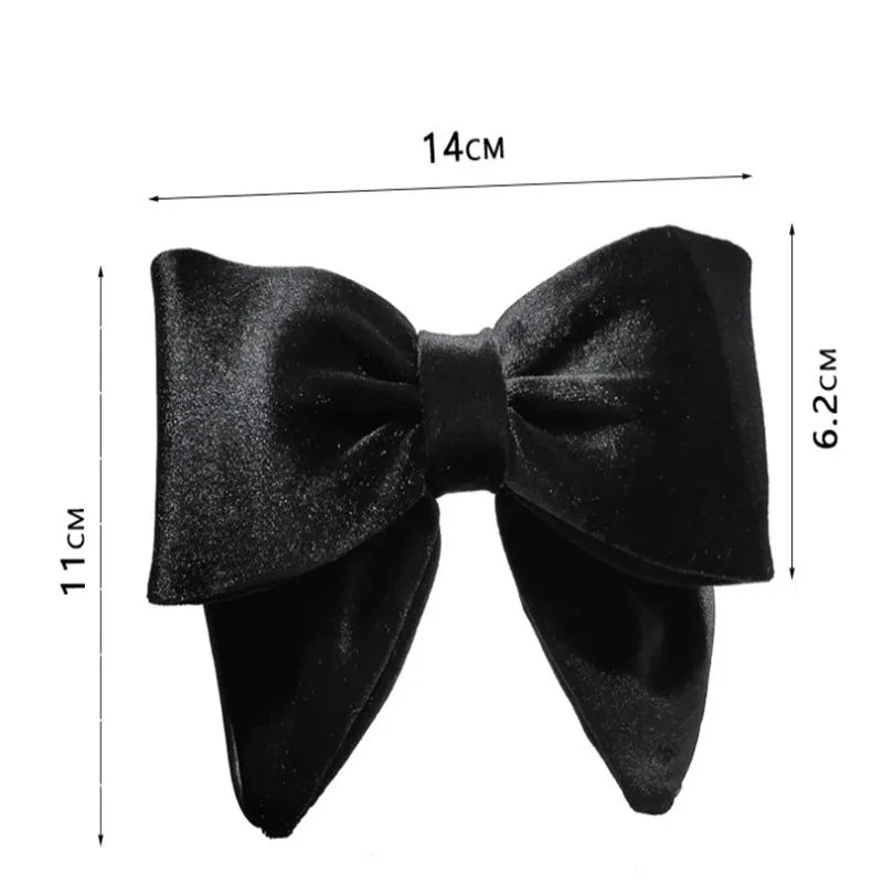 Black velvet bow hair clip with measurements showing 14cm width and 11cm height