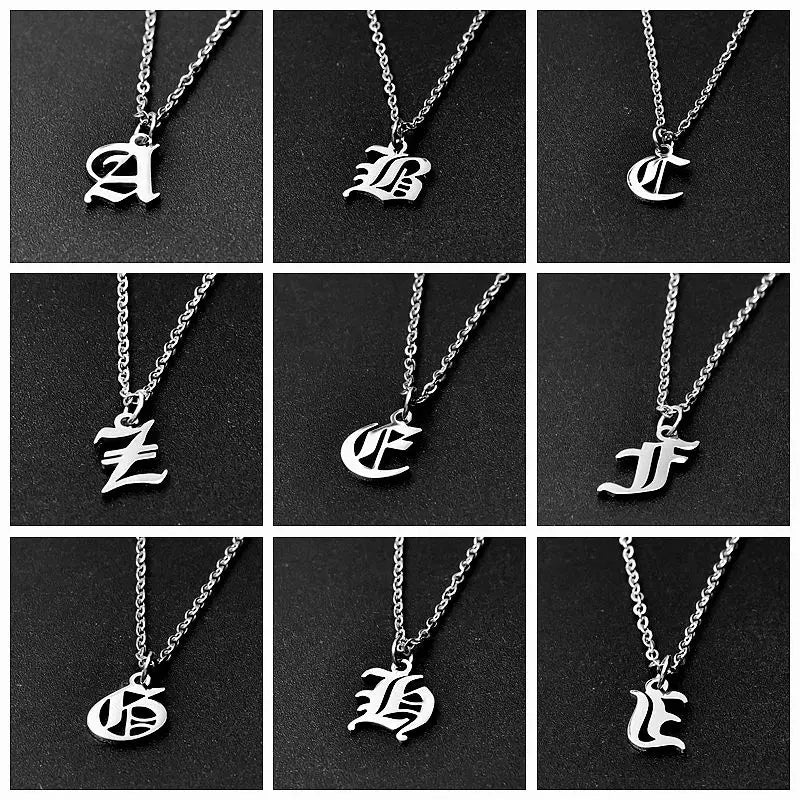 A collection of silver initial pendant necklaces featuring Old English lettering