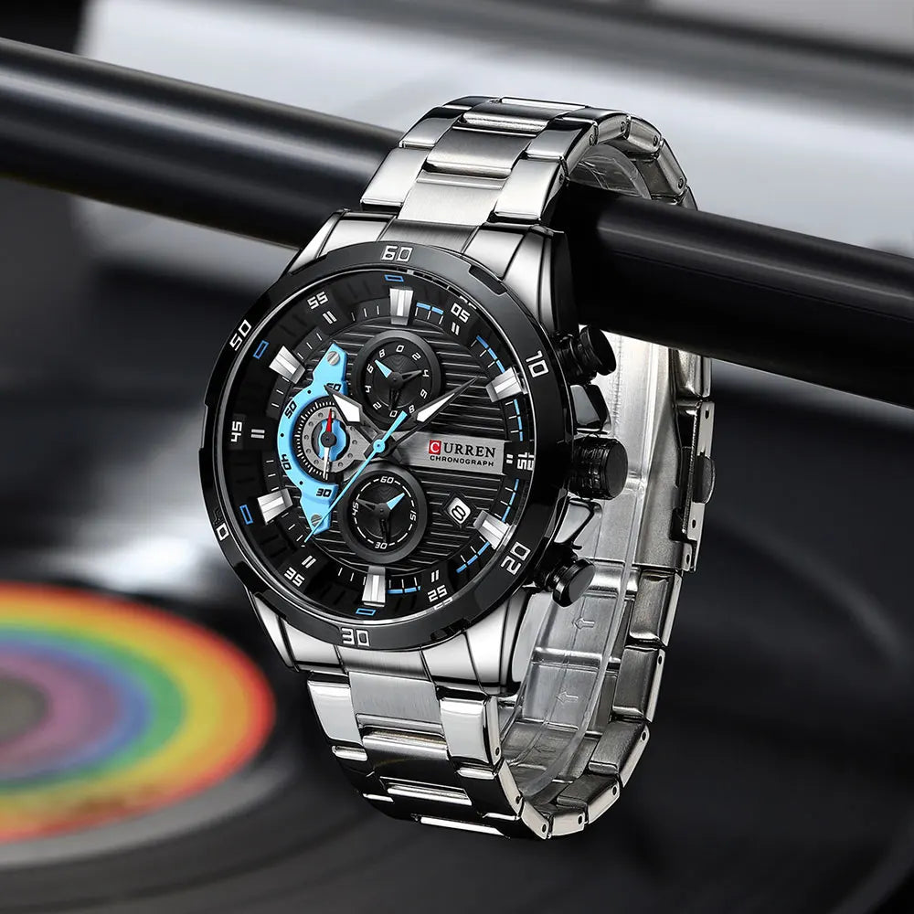 Silver stainless steel chronograph watch with a black and blue dial on a dark background.
