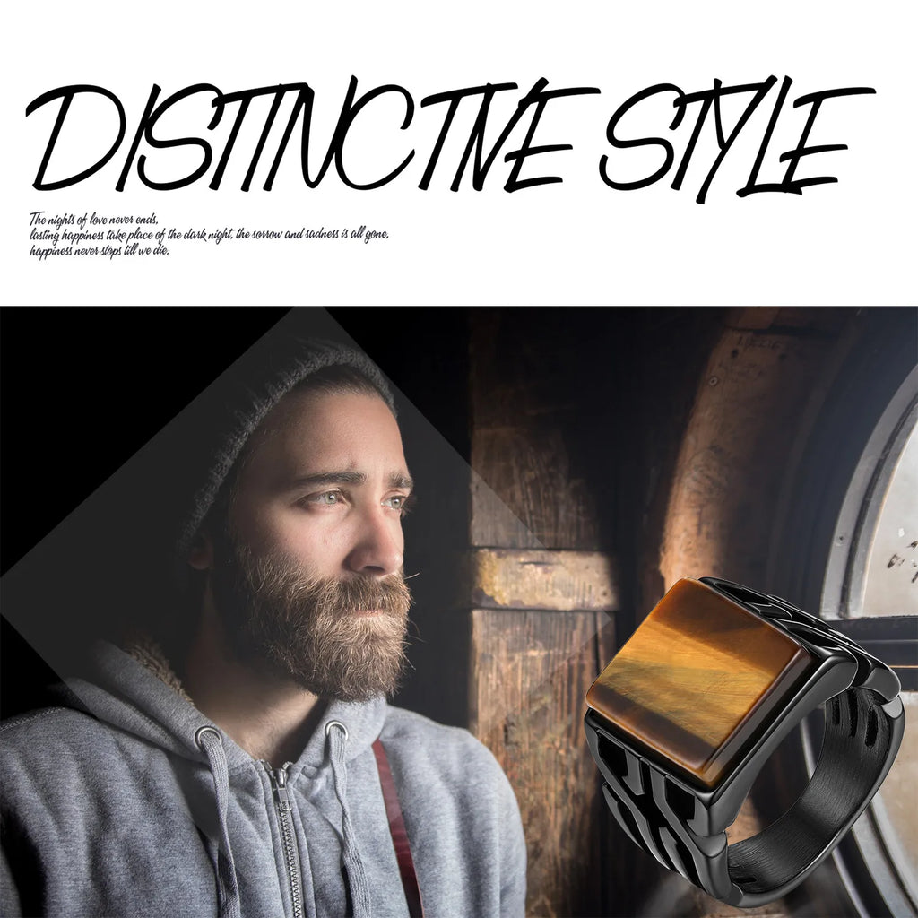 A man wearing a black stainless steel ring with a tiger eye stone