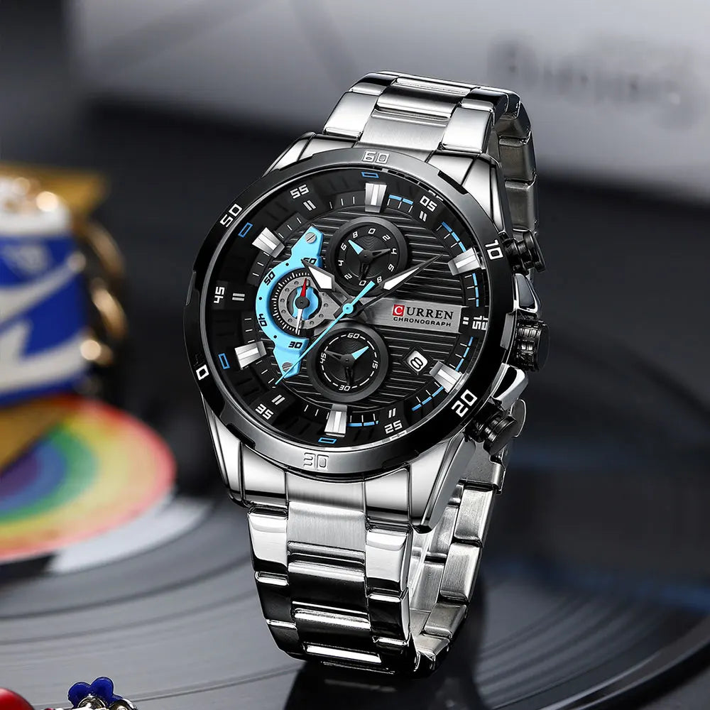 Silver stainless steel chronograph watch with a black and blue dial on a dark background.