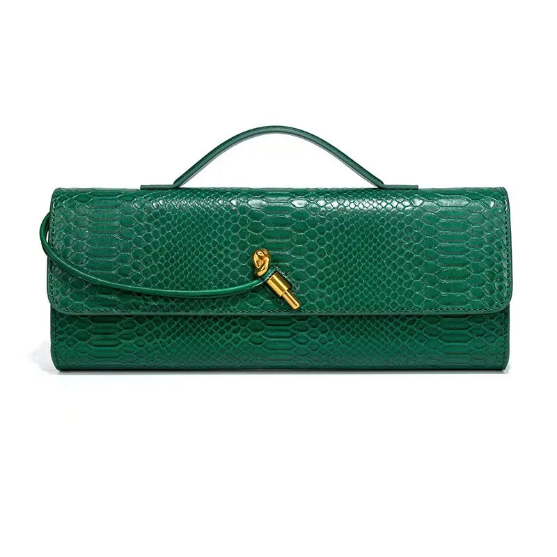 Green faux crocodile skin long clutch bag with a top handle and gold knot clasp