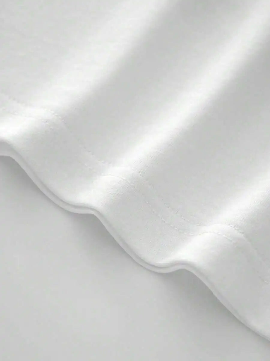 Close up of the hem of a plain white t-shirt