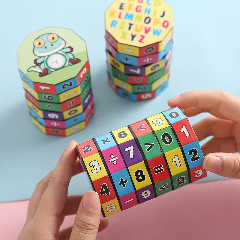 Two standing math cylinder puzzles and one being held, featuring numbers and symbols