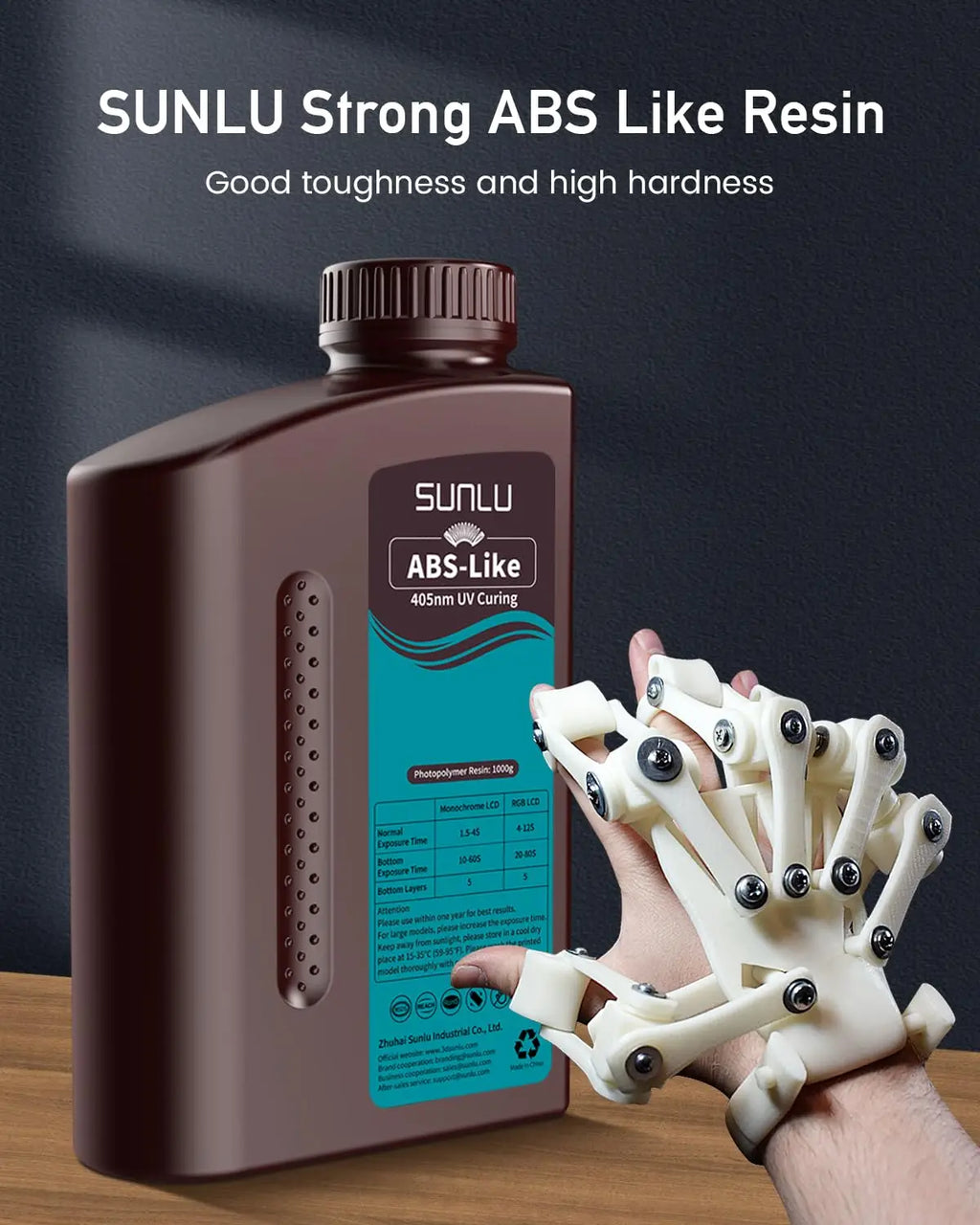 A 3D printer resin bottle beside a 3D printed mechanical hand prototype.