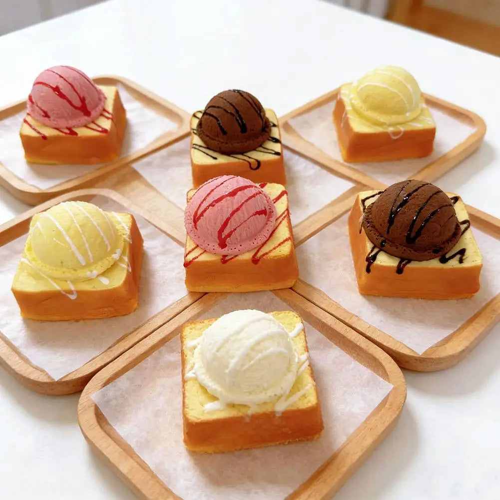 Assortment of ice cream bread squishy toys on small wooden plates