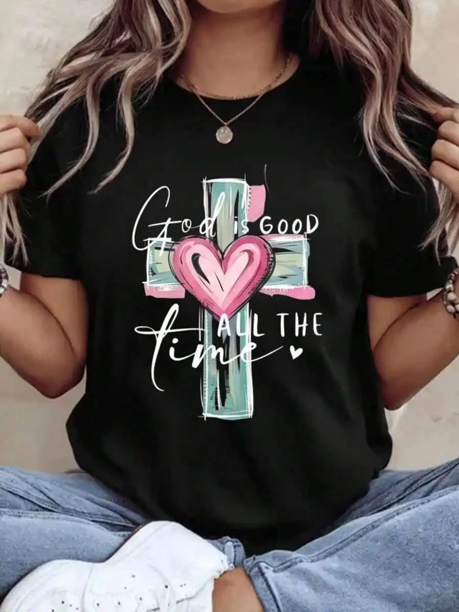 A woman wearing a black t-shirt with a religious cross and heart graphic print.
