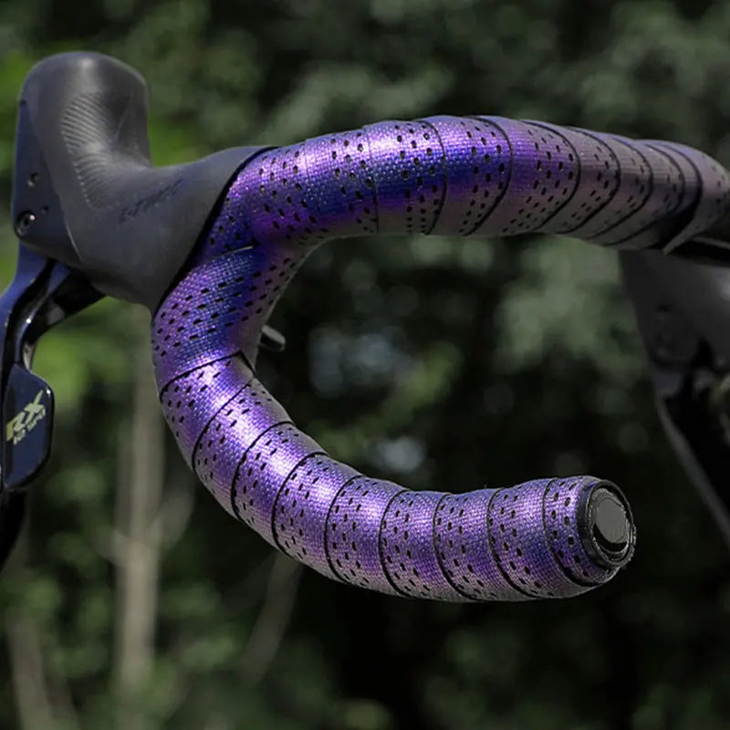 Close up of purple iridescent bike handlebar tape on drop bars.
