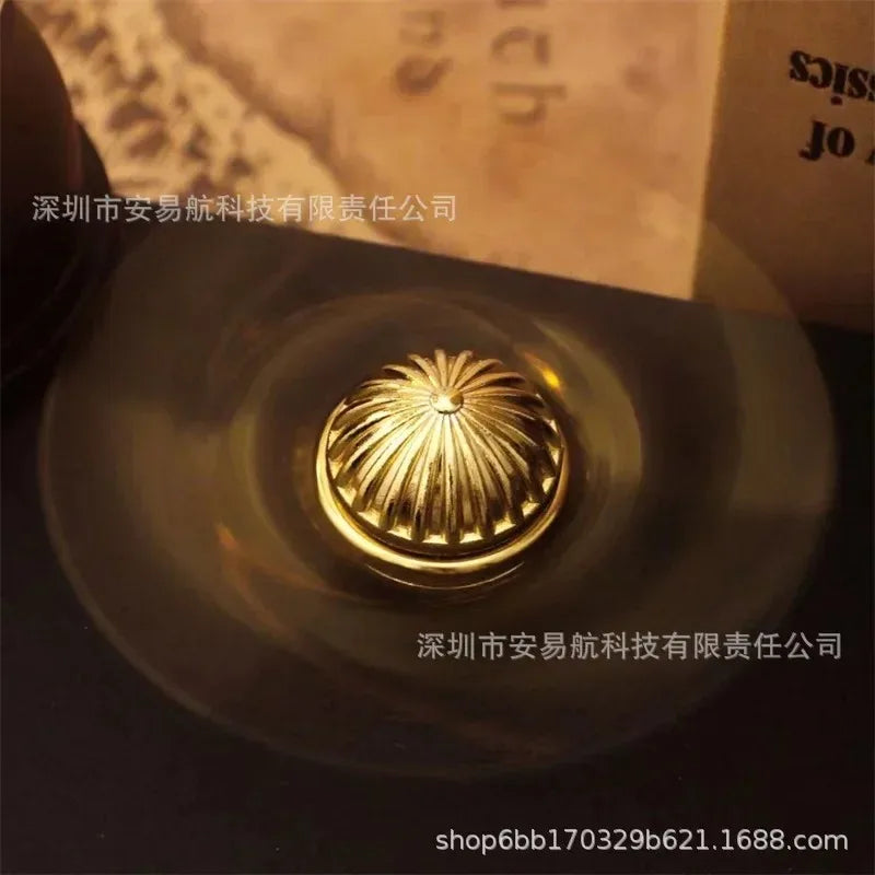 Top view of a golden snitch fidget spinner resting on a surface
