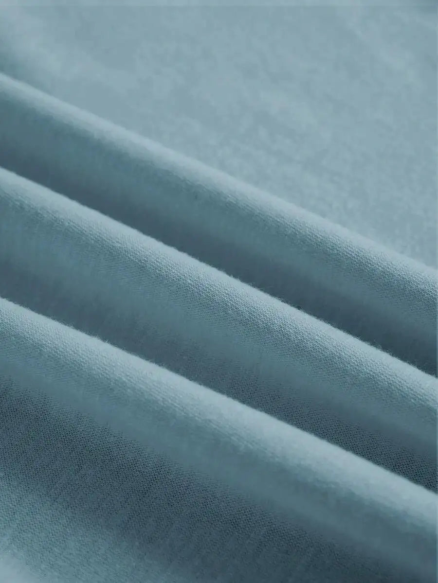 Close-up of the light blue t-shirt fabric showing soft folds and texture