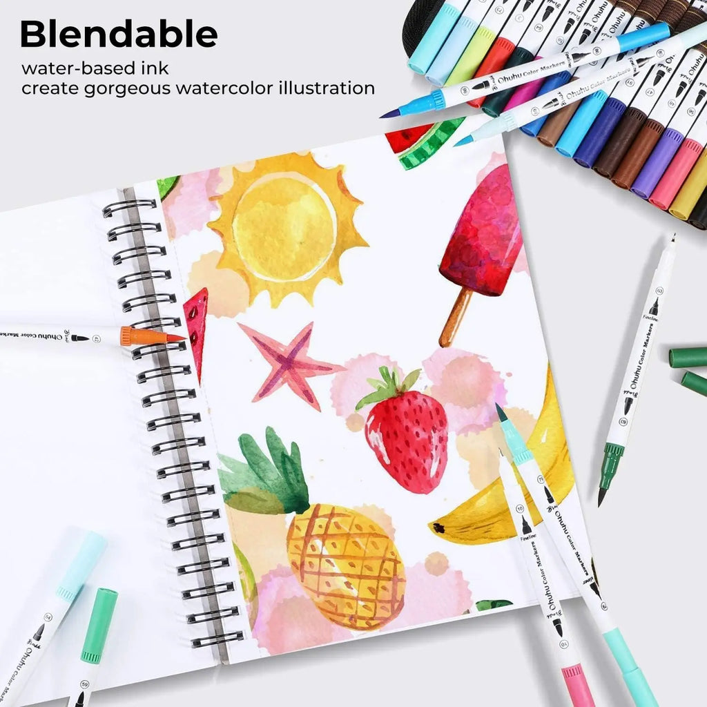 Dual-tip markers shown with a spiral-bound sketchbook featuring colorful hand-drawn fruit and sun illustrations.