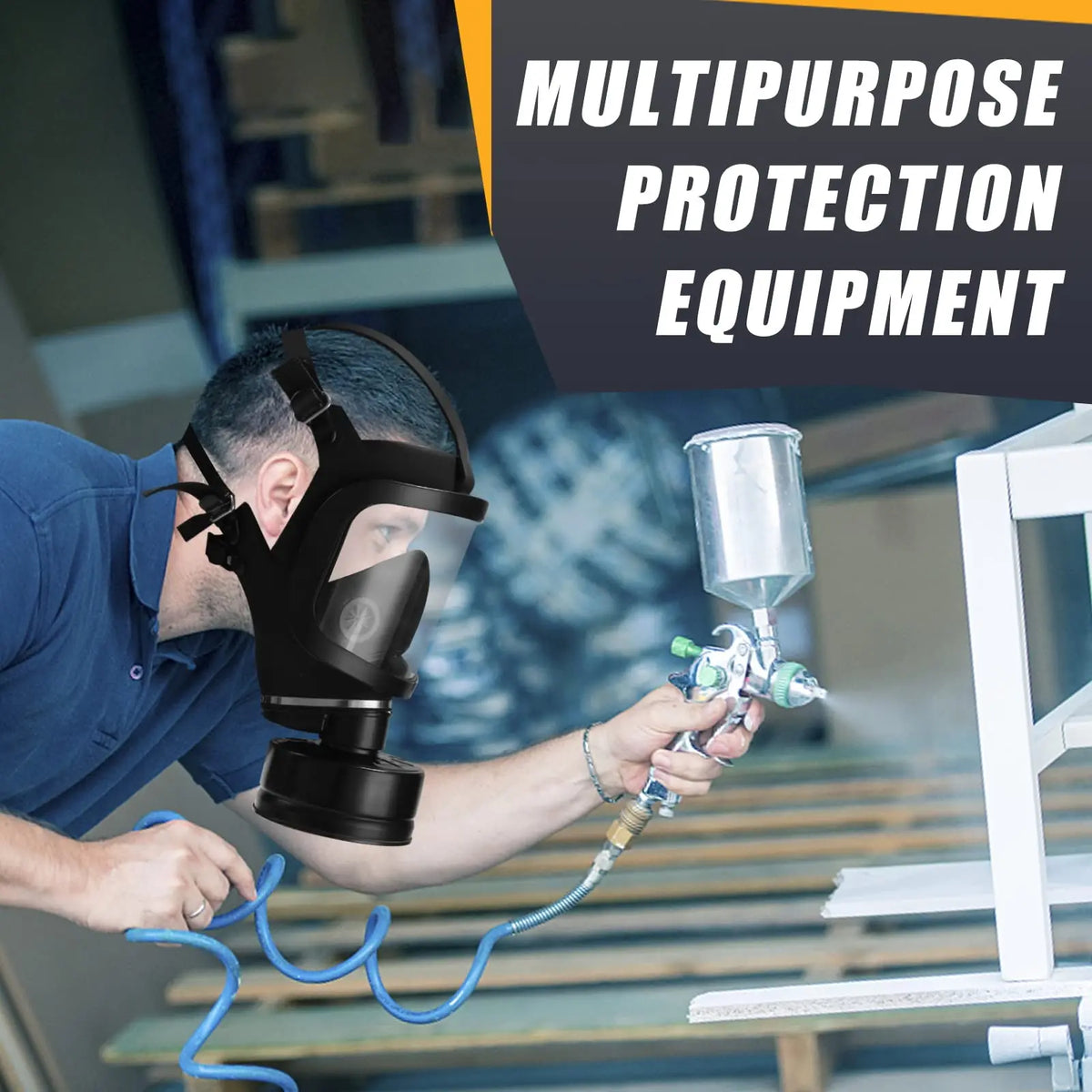 A man wearing a full face gas mask while using a paint sprayer in a workshop