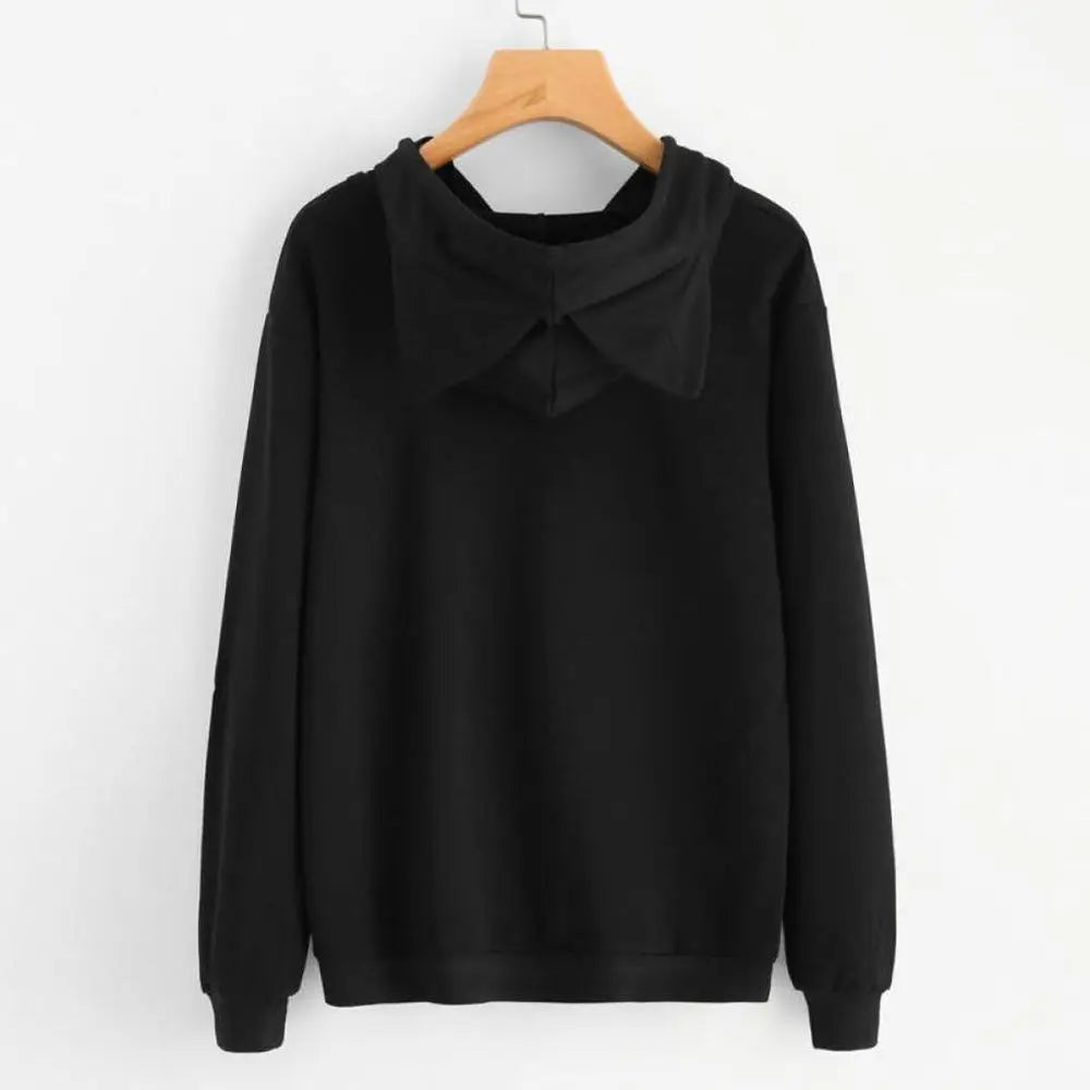 The back of a plain black hooded sweatshirt with cat ears on the hood.