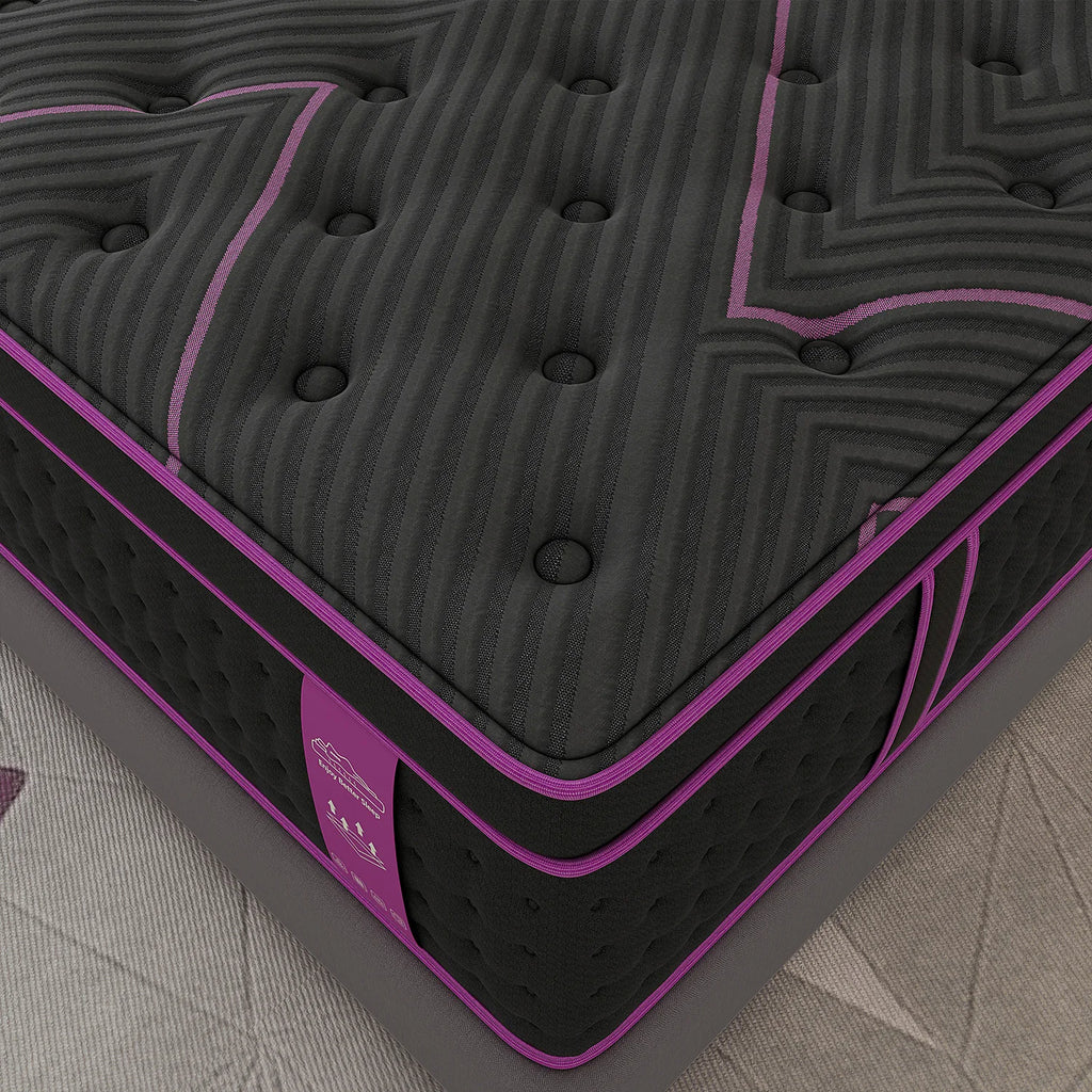 A close-up view of the corner of a black and purple hybrid mattress.