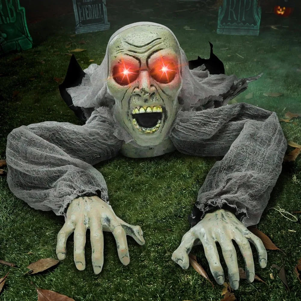 Halloween groundbreaker zombie decoration with glowing red eyes on grass.