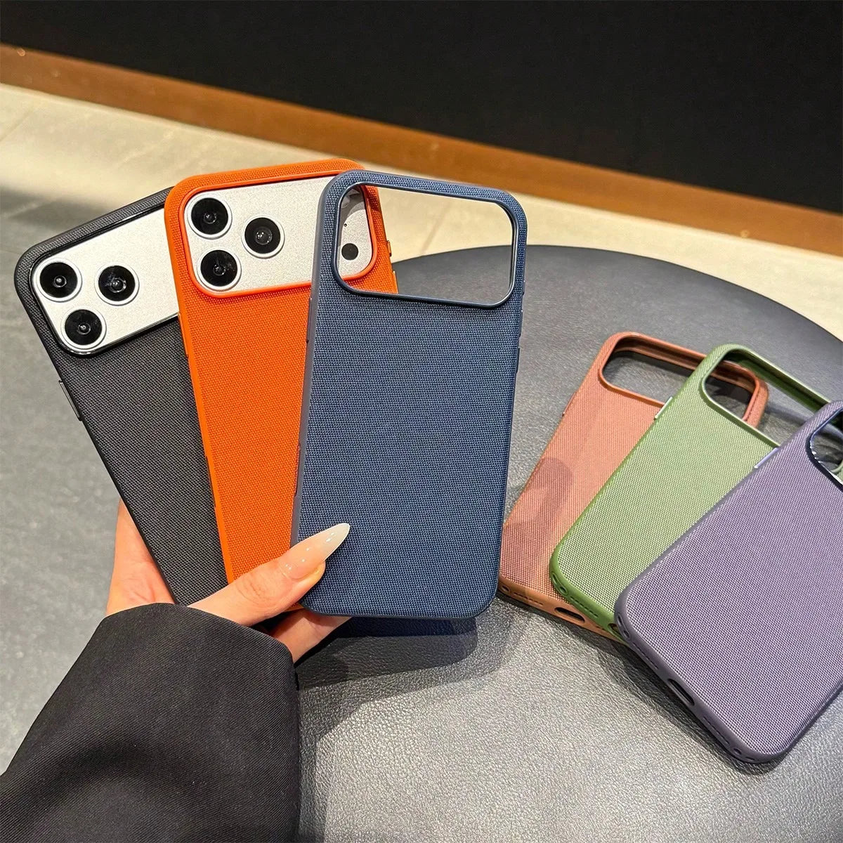 Set of multiple woven fabric phone cases in various colors