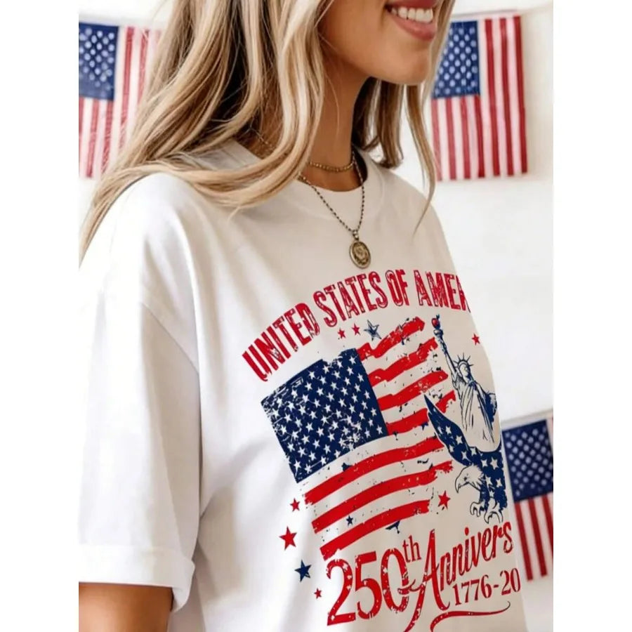 A close-up view of a woman wearing a white t-shirt with a patriotic American flag graphic.