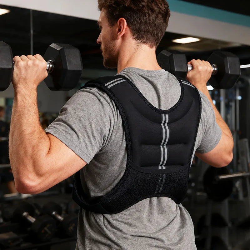 Man performing overhead press while wearing a black weighted vest.