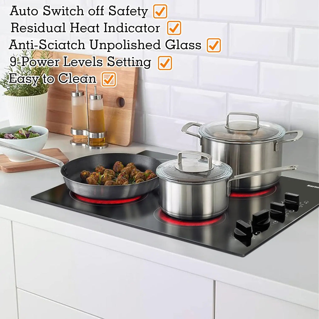 Electric cooktop installed in a kitchen counter with stainless steel pots and pans