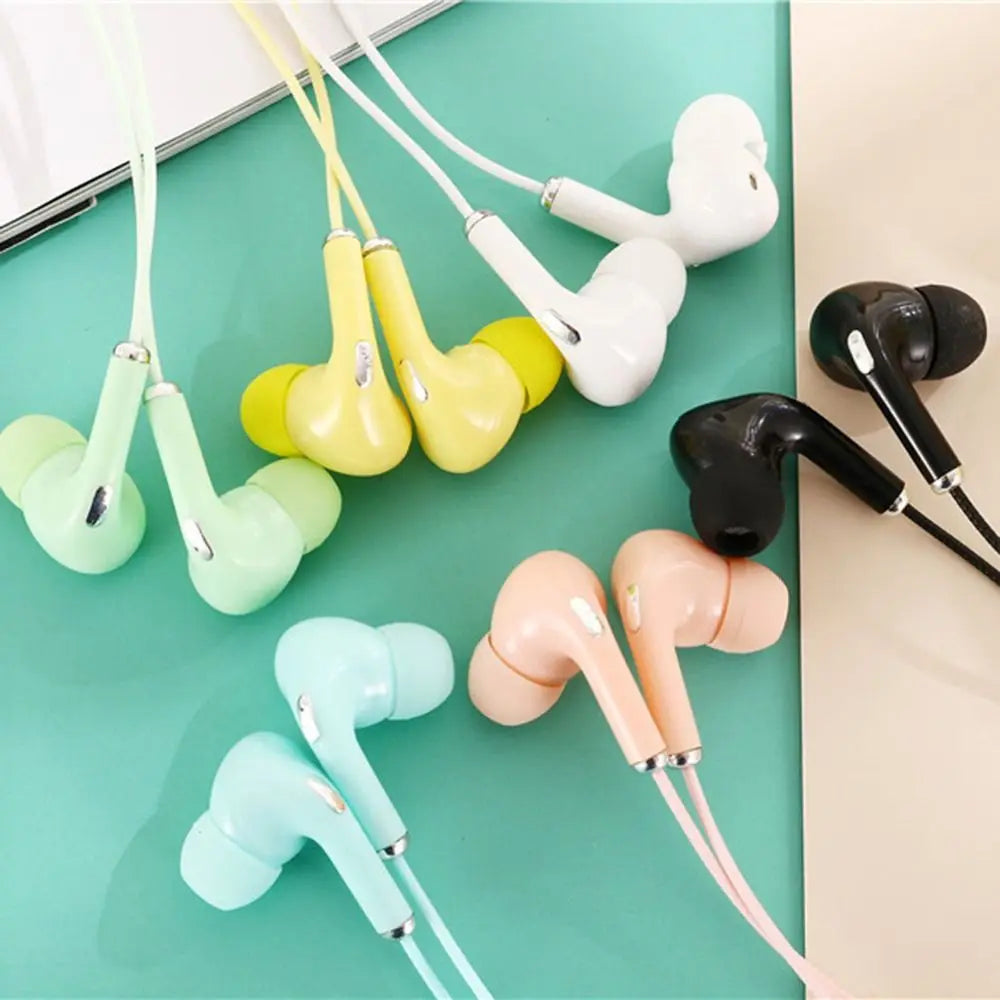 A close-up of various colors of wired in-ear headphones with silicone tips.