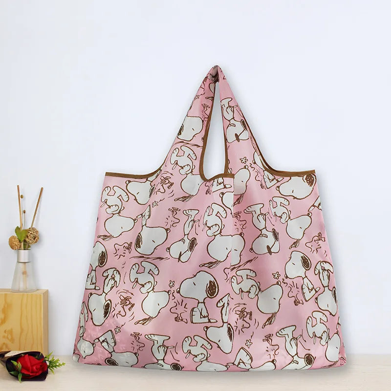 A pink foldable shopping bag with a cartoon dog print.