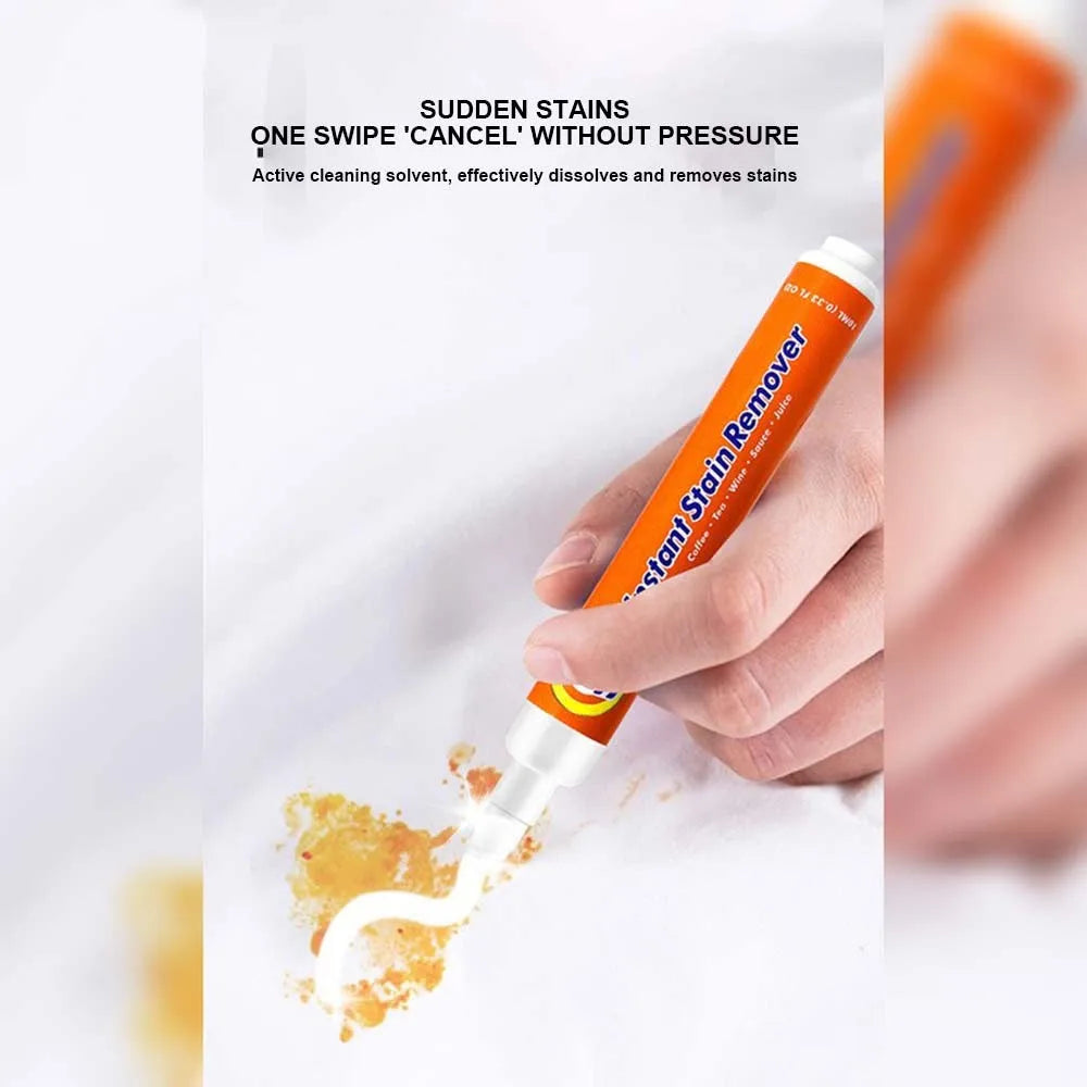 Hand using an orange and white stain remover pen on a fabric stain