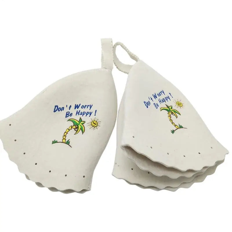 Two white felt sauna hats with palm tree and text embroidery.