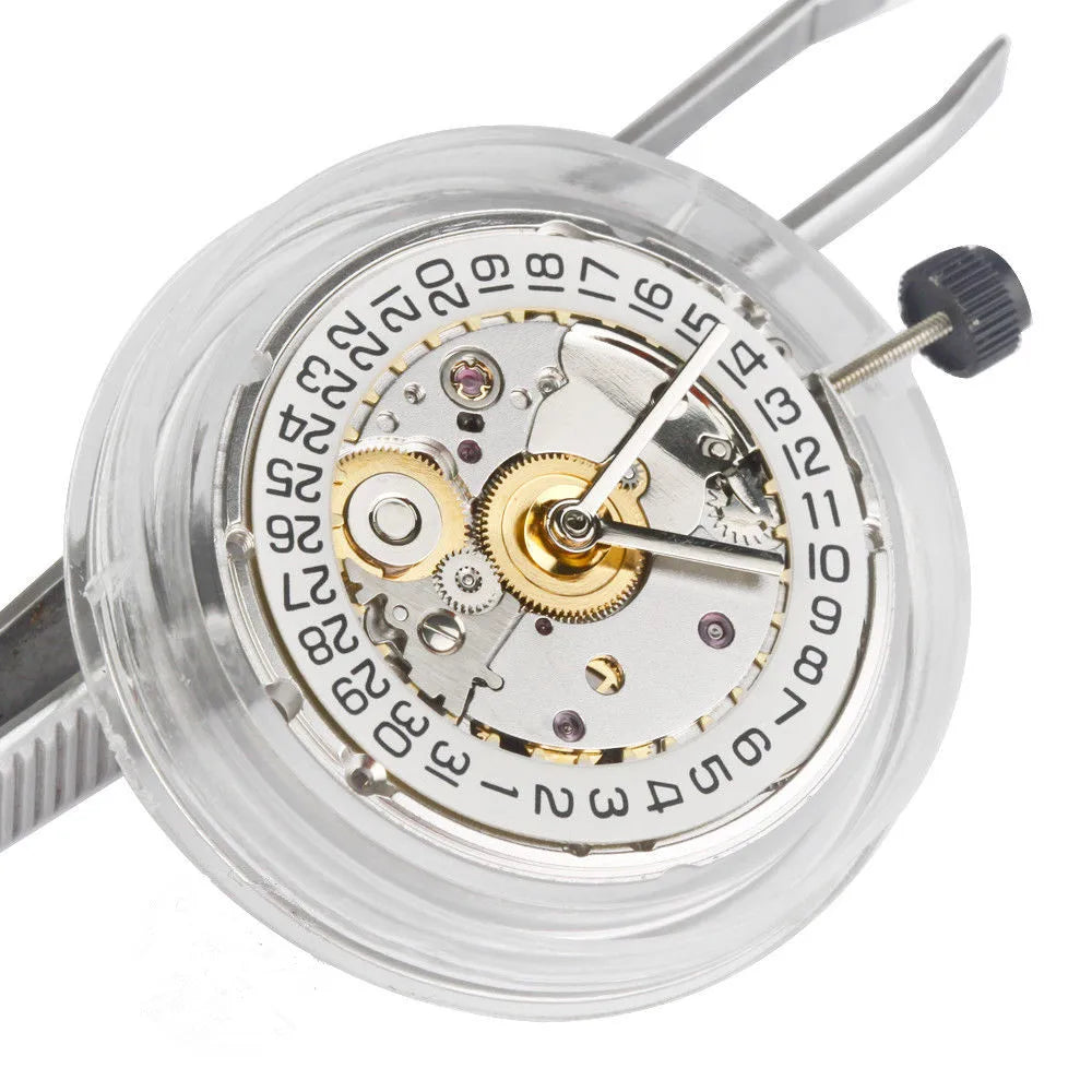 Automatic watch movement with date wheel held by tweezers