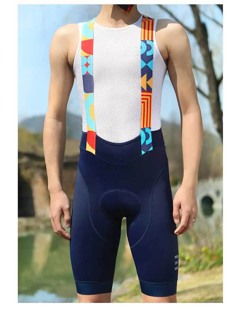 Man wearing navy cycling bib shorts with white mesh top and patterned shoulder straps