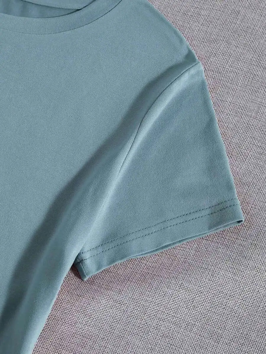 Close-up view of the back side of a light blue t-shirt fabric texture