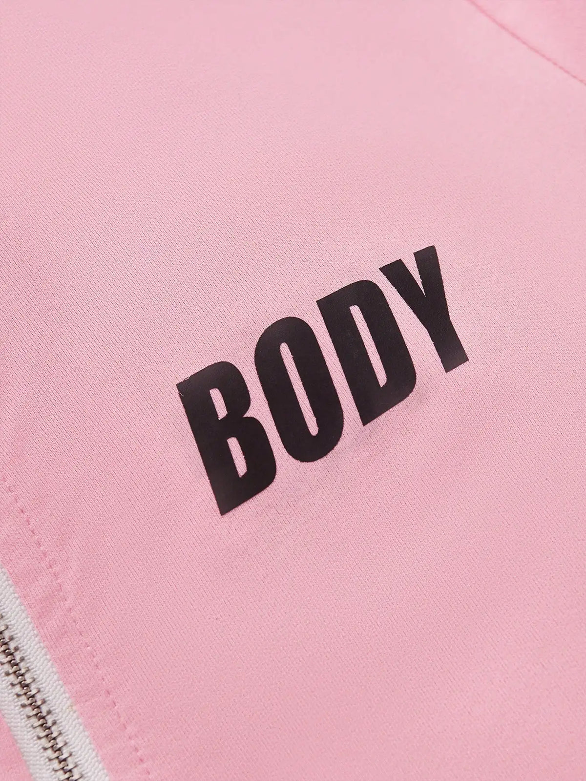 Close-up of the black lettering printed on pink fabric.