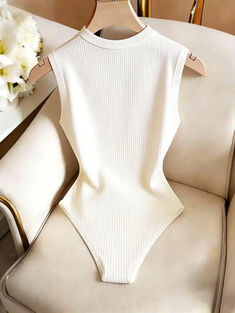 Sleeveless off-white ribbed knit bodysuit with gold decorative buttons on the shoulders
