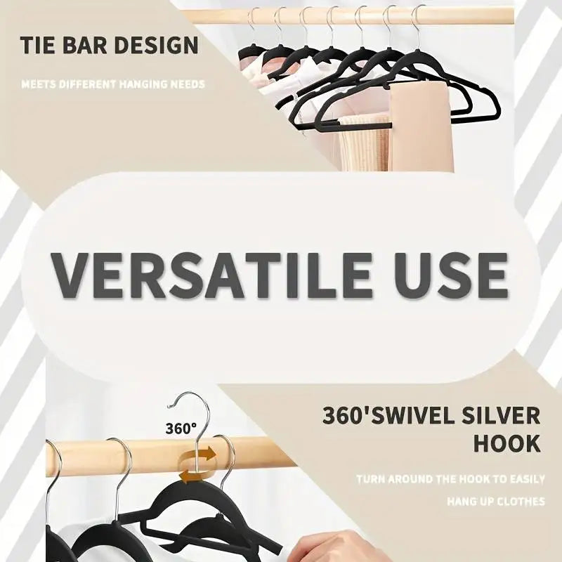Black velvet hangers on a clothing rack highlighting the tie bar design and 360 degree swivel hook.