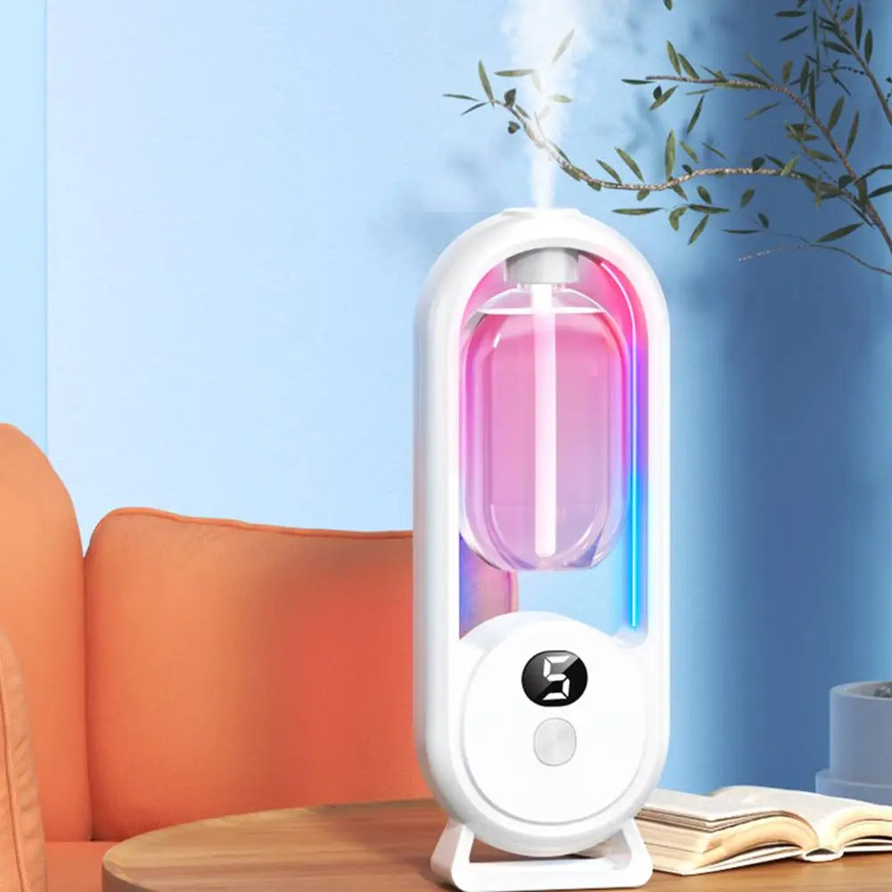 White automatic fragrance diffuser with digital display on a wooden surface
