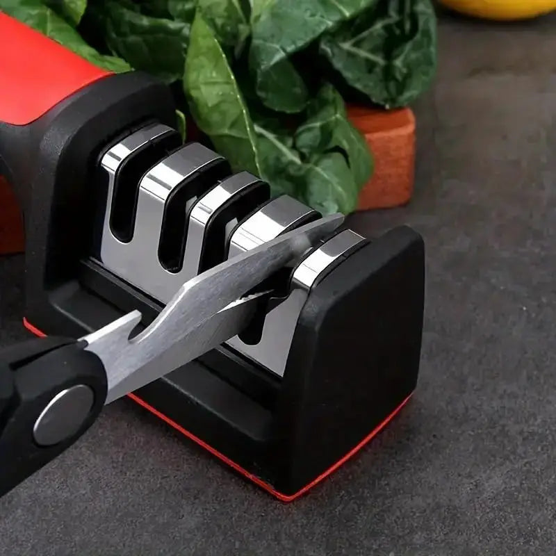 Close up of a manual knife sharpener sharpening a kitchen knife.