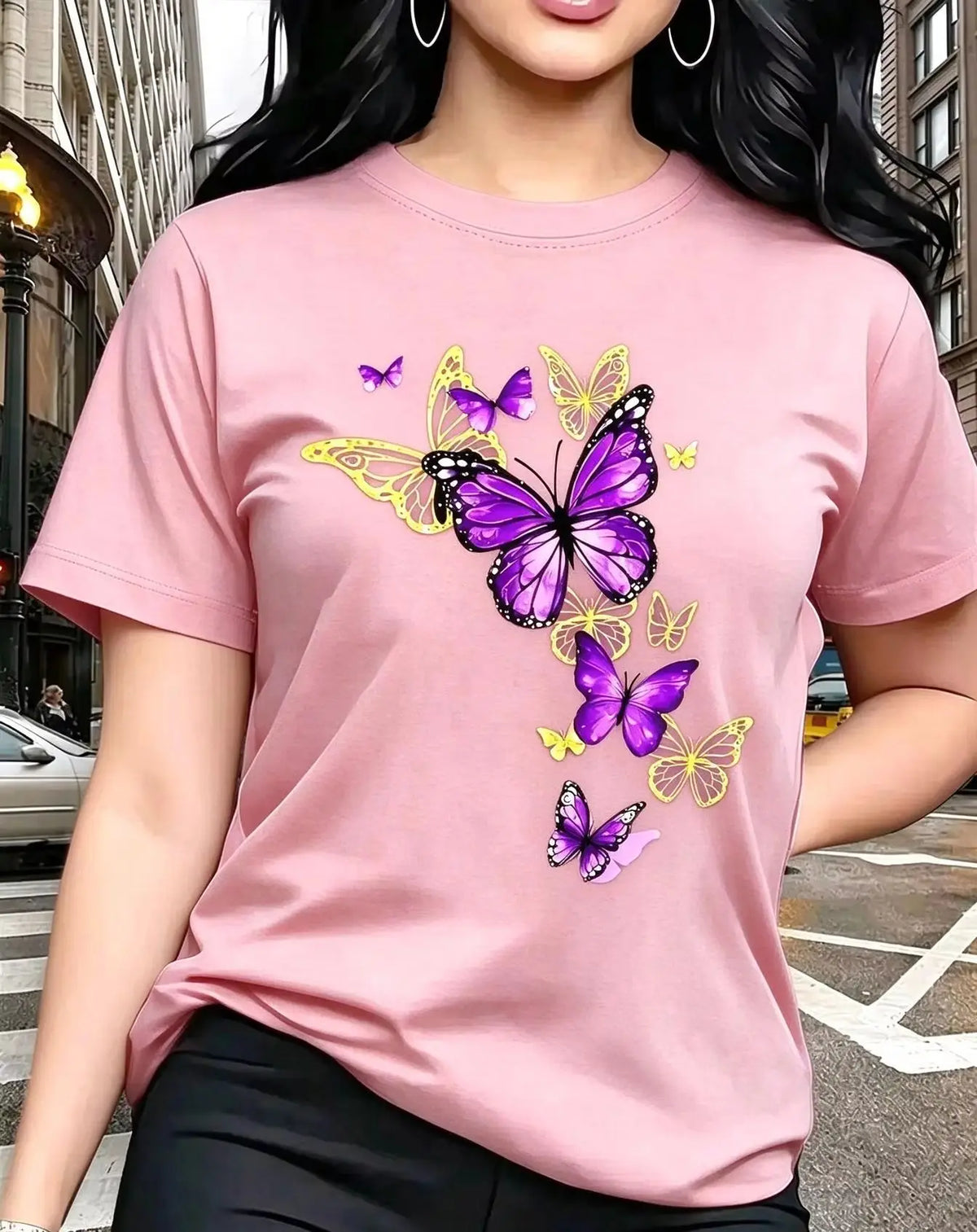 A pink short-sleeved t-shirt with a printed butterfly design, worn by a woman.