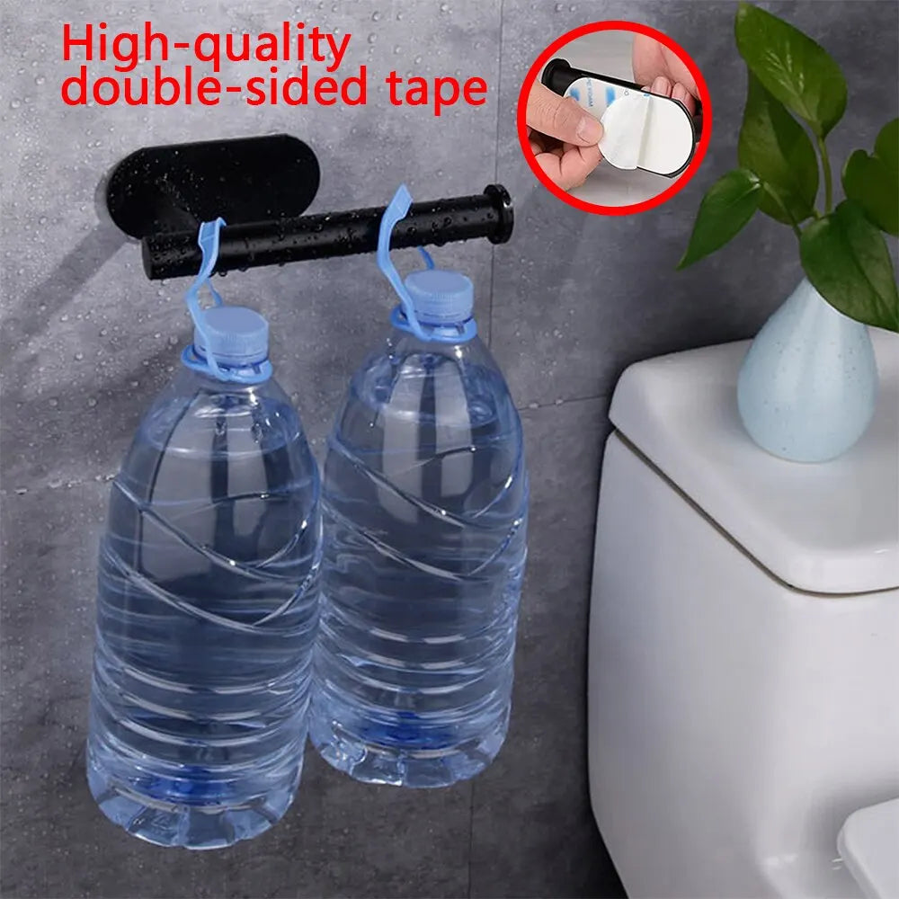 Wall-mounted adhesive toilet paper holder showing load-bearing capacity with water bottles