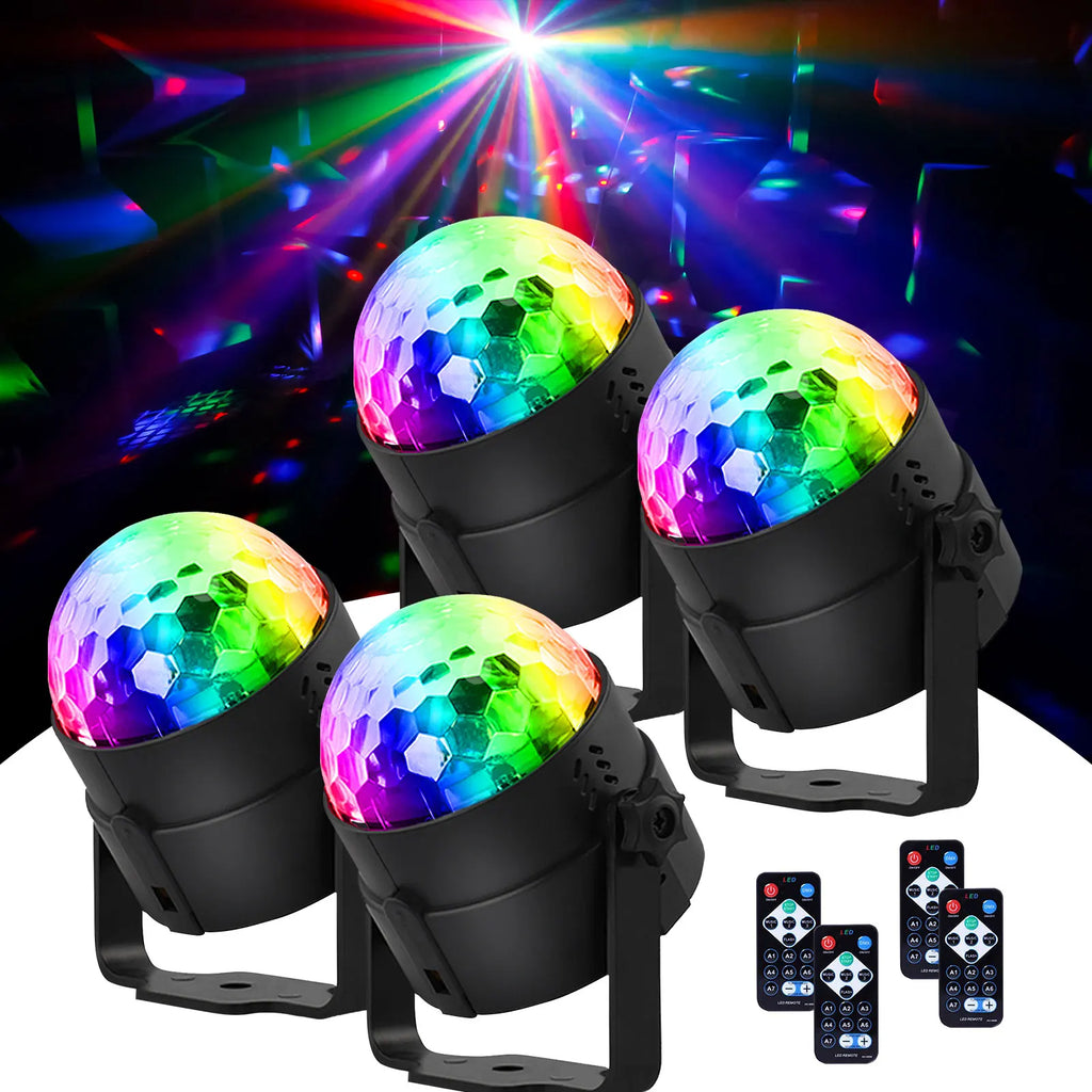 Four multicolored LED disco balls with remote controls and light beam background