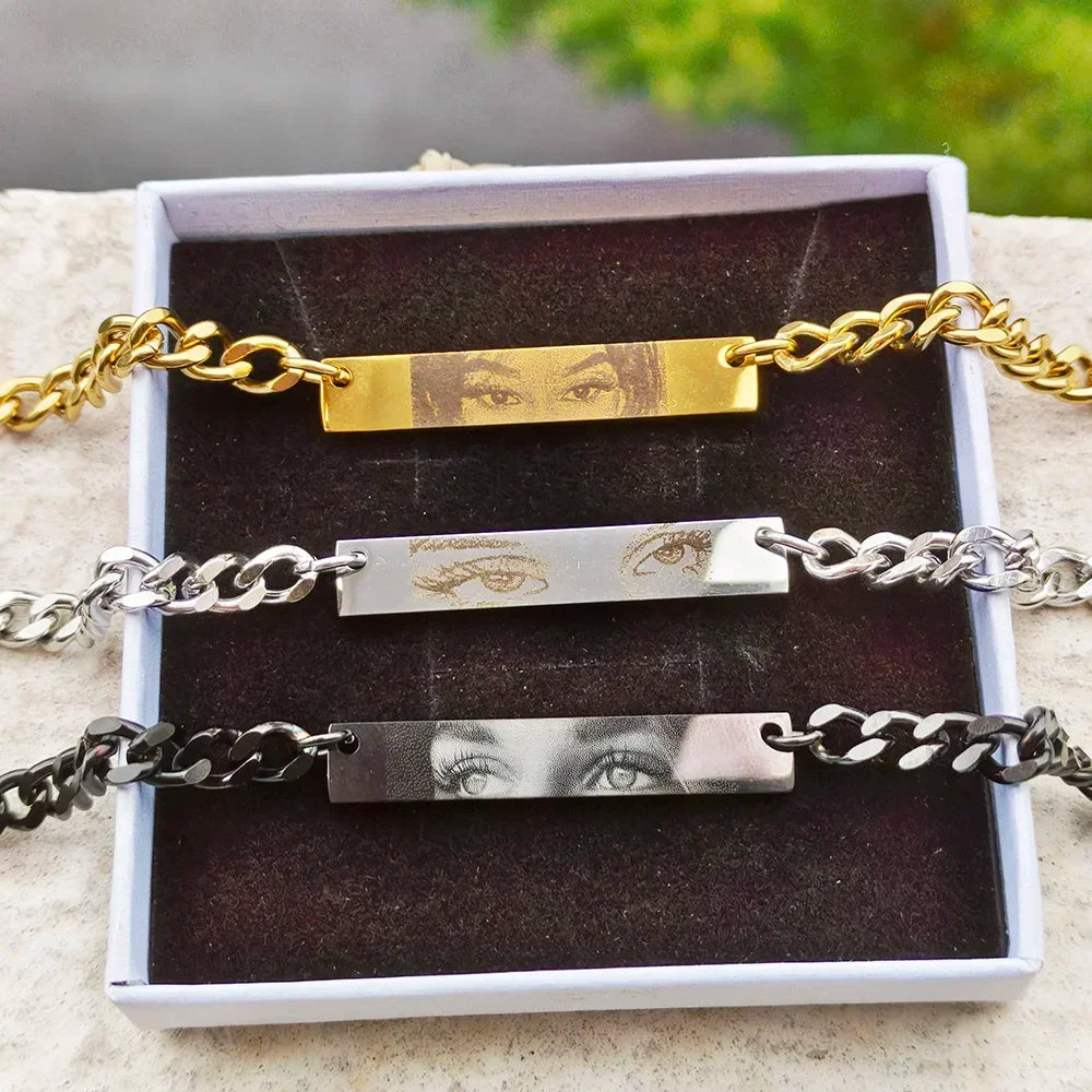 Three personalized photo engraved bar bracelets in gold, silver, and black tones inside a gift box.