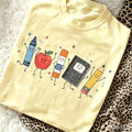 Cartoon School Supplies Graphic T-Shirt for Teachers and Students – Yellow