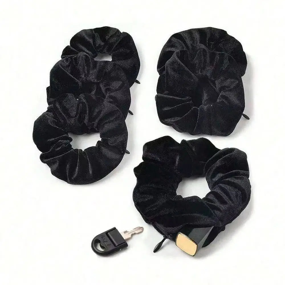 A set of four black velvet hair scrunchies with zipper pockets, including a key.