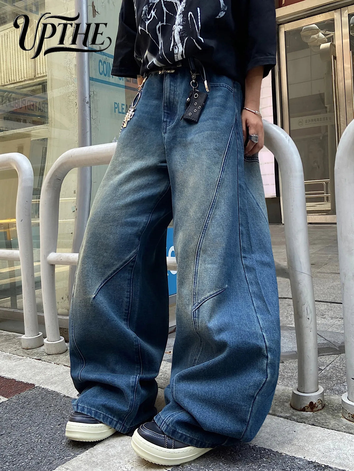 Men's vintage blue baggy wide-leg jeans with spliced panels and streetwear aesthetic