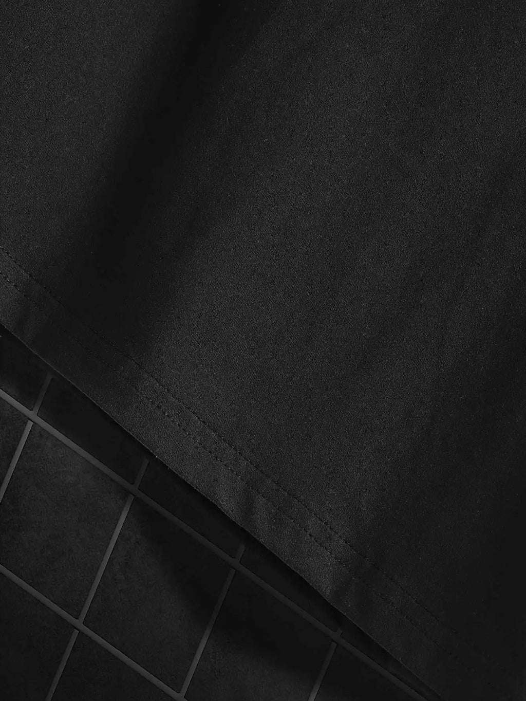 Close-up of the bottom hem of a black t-shirt