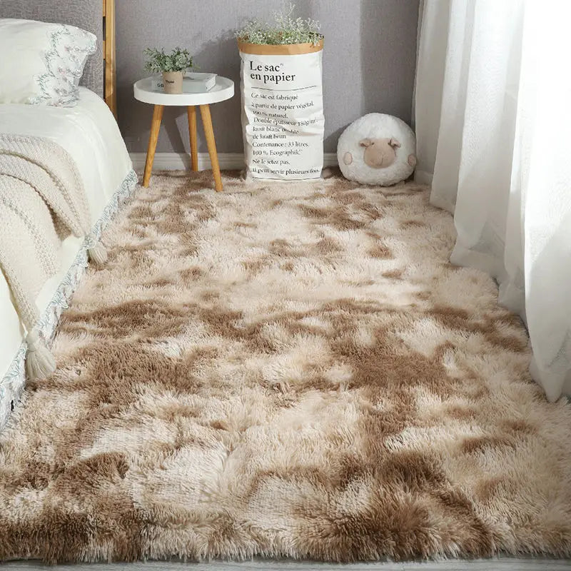 Brown and beige tie-dye style plush area rug in a bedroom.